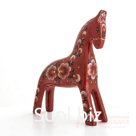 A fiery red horse with a floral pattern