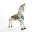 White horse with a large flower